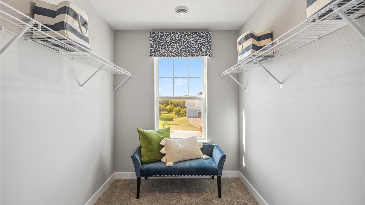 Walk in closet with view of the community.