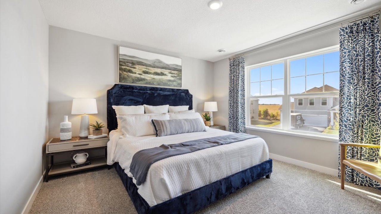 Bedroom suite with dual walk-in closets and private bathroom.
