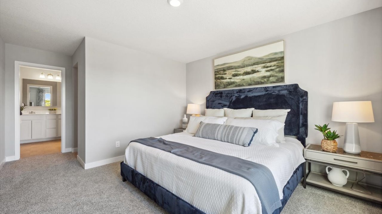 Bedroom suite with dual walk-in closets and private bathroom.