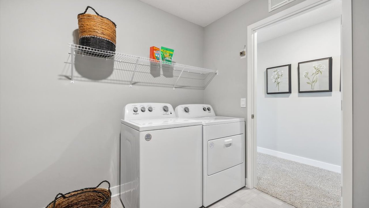 Upper level laundry room with wire shelving unit.