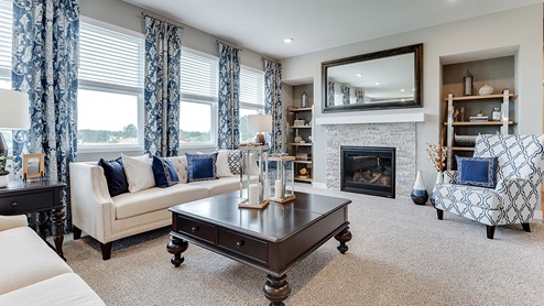 Family room with a gas fireplace and stone surround.