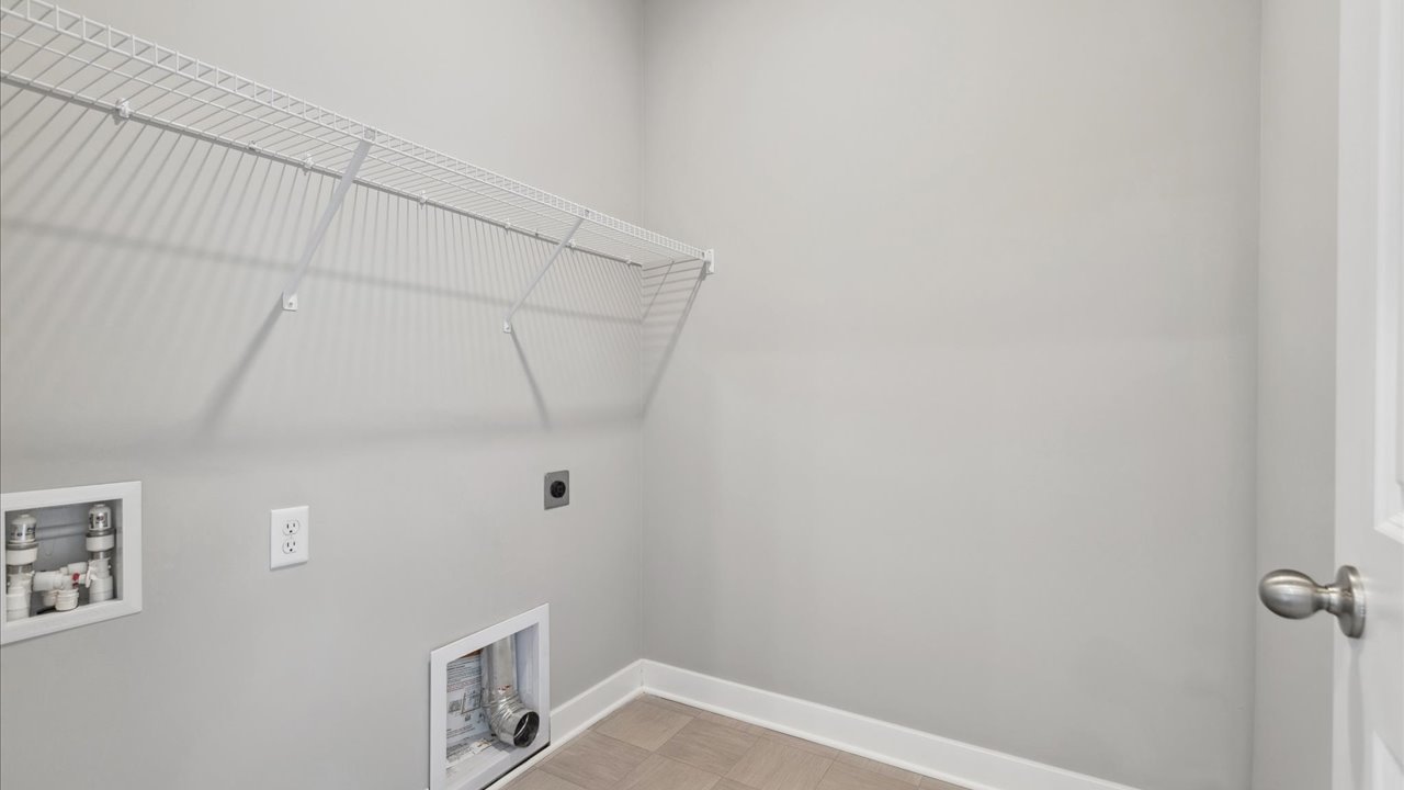 Laundry room with wire shelving unit.