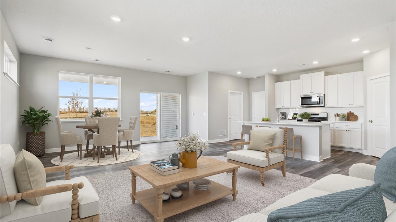 Open concept main level with dinette, kitchen, and carpeted living room.