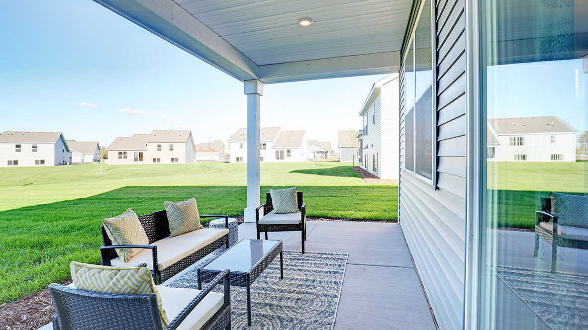 Concrete patio with view of backyard.