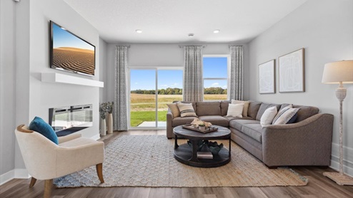 Living room with hard flooring and electric fireplace.