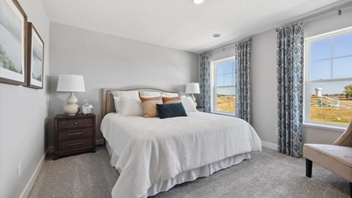 Bedroom suite with dual walk-in closets and private bathroom.