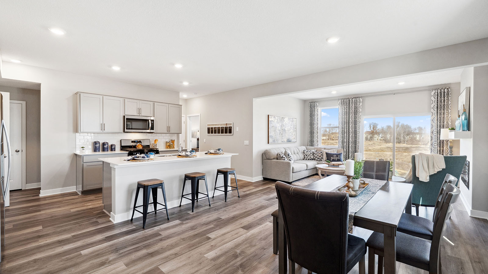 Open concept main level with living, kitchen, and dinette areas.