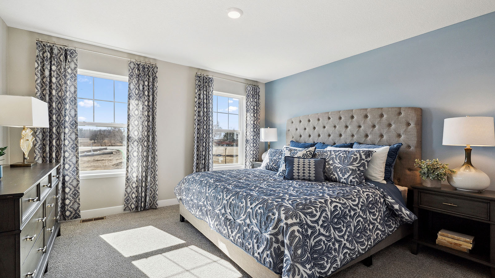 Bedroom suite with dual walk-in closets and private bathroom.