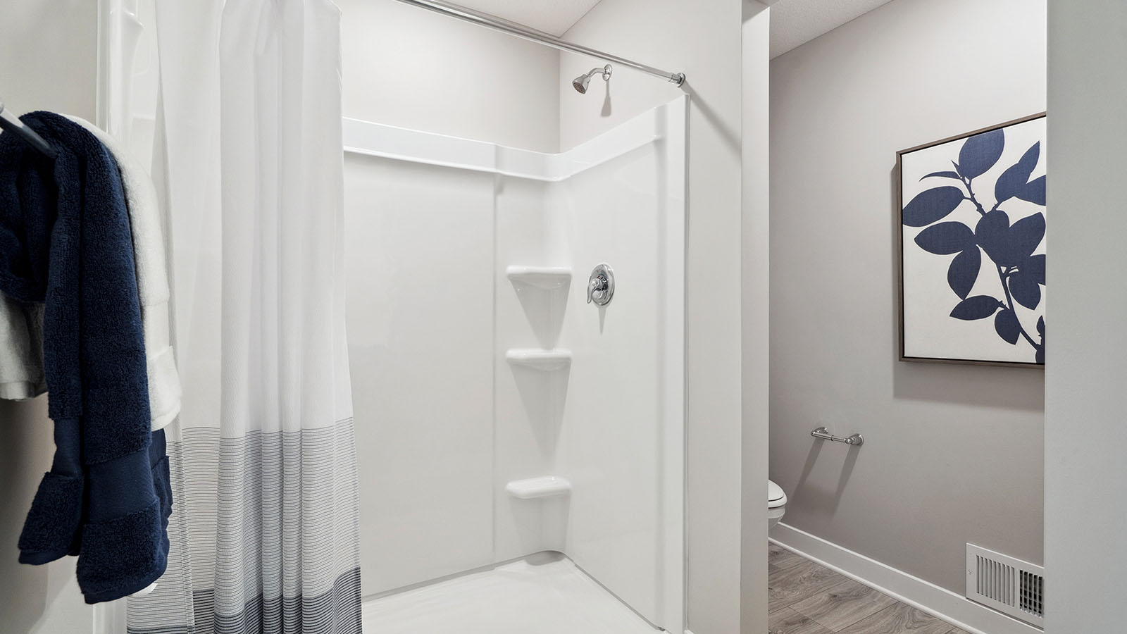 Private bathroom with gray double sink vanity and quartz vanity countertop.