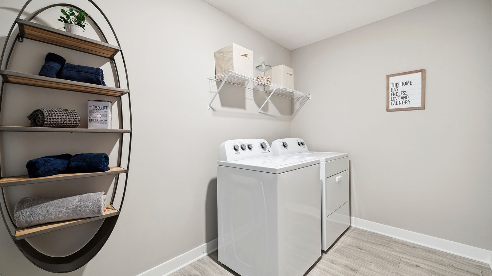 Upper level laundry room with wire shelving unit.