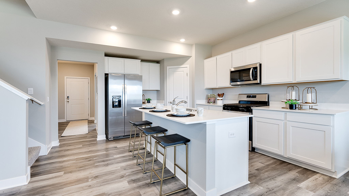 Angled view of kitchen with four-person island.