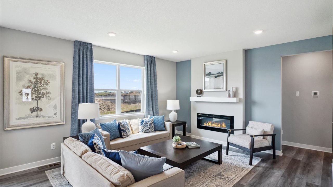 Living room with hard flooring and electric fireplace.