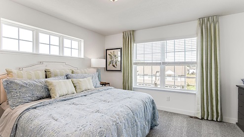 Carpeted bedroom suite with private bathroom and walk-in closet.