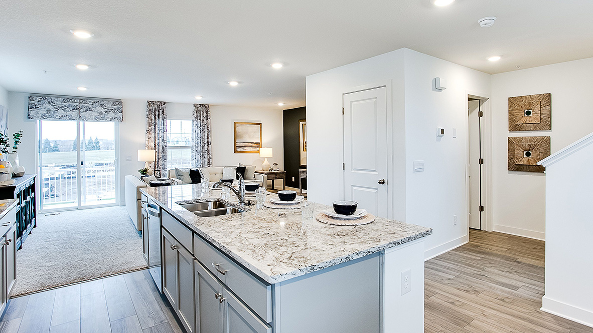 kitchen with light grey cabinetry, large island and stainless steel appliances