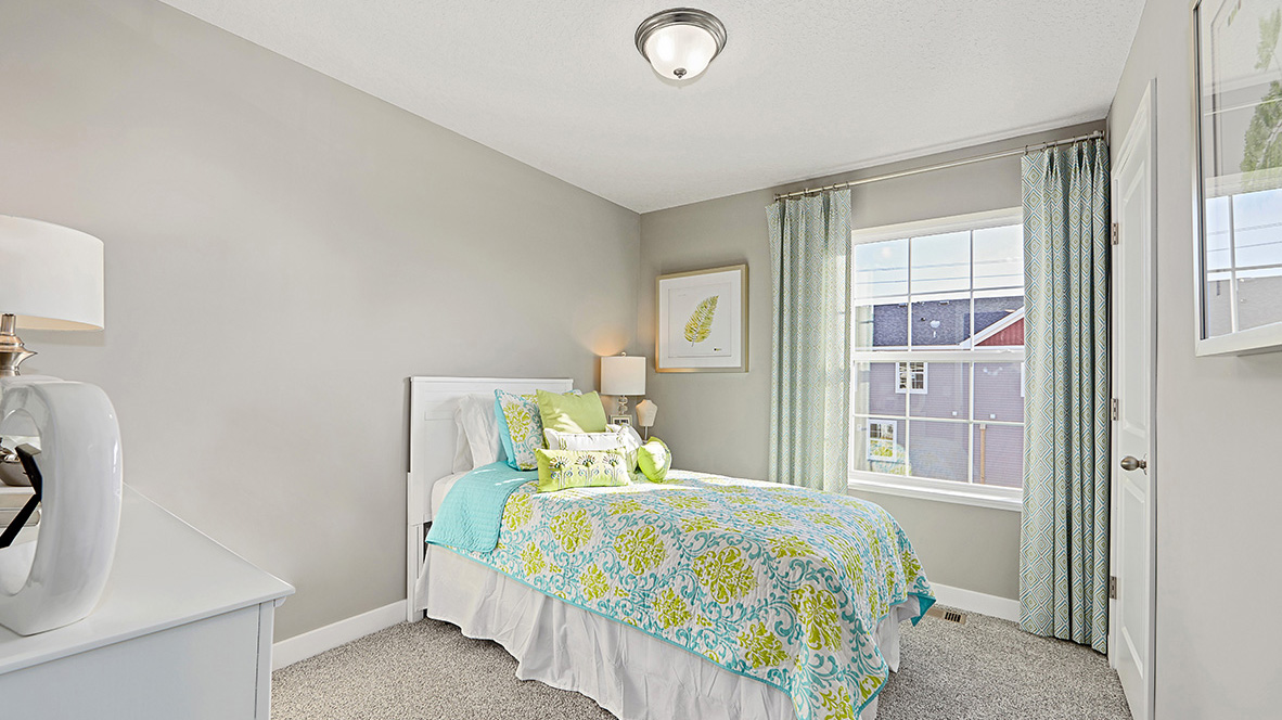 Carpeted secondary bedroom.