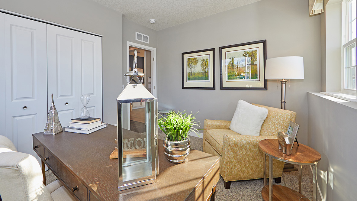 Lower level flex room with a desk and chairs.