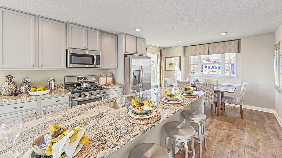 Open concept main level with view of kitchen and dinette.