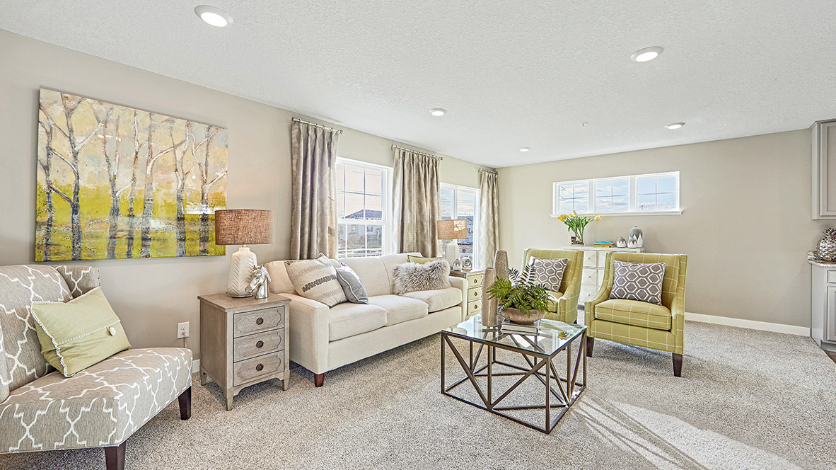 Carpeted living room adjacent to kitchen.