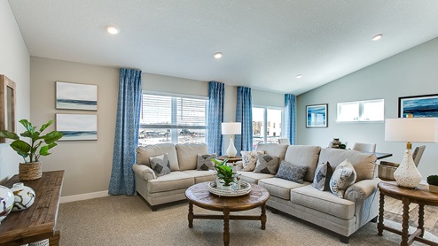Vaulted main level ceilings make the family room look dramatic.