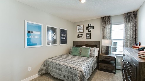 Secondary bedroom on the upper level staged as a boy's room.