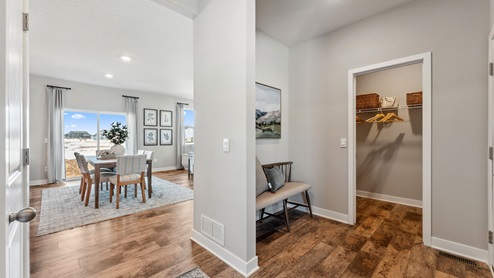 front entry way of home overlooking the dining room and coat closet