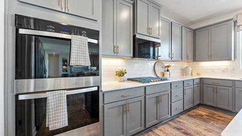 kitchen with grey cabinetry, large island and stainless steel appliances