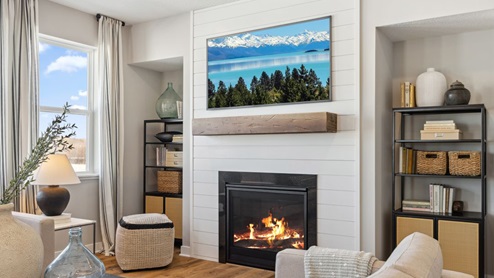 living room with a sleek black fireplace, floating mantle with a TV aboce