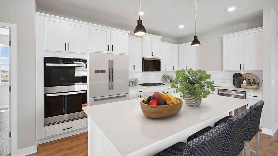 kitchen with white cabinetry, large island, and stainless steel appliances