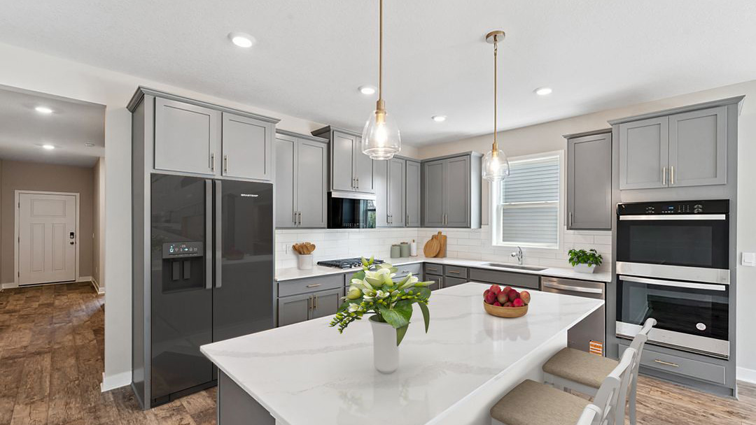 Interior kitchen with center island and light grey cabinets