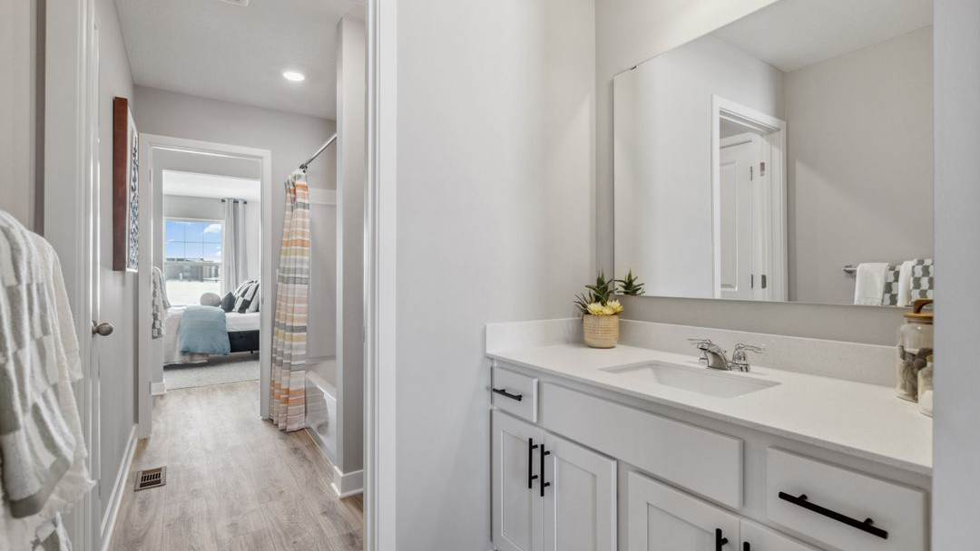 bathroom with a vanity sink, toilet and shower