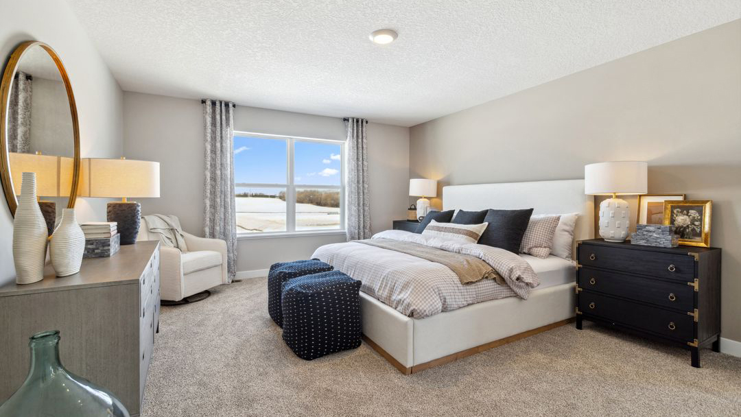 bedroom with beige carpet, grey walls and a window