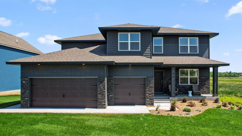 front exterior of a two story home with a three car garage
