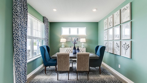 Formal dining area full of windows and hard flooring.