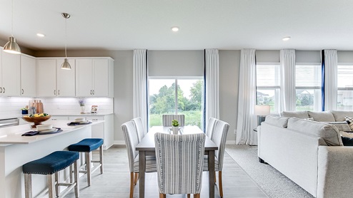 Informal dining area next to the kitchen with a sliding glass door to a future deck.
