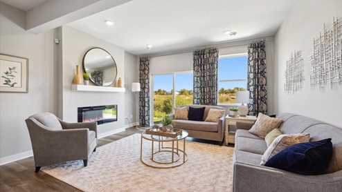 The Elm plan family room with electric fireplace.