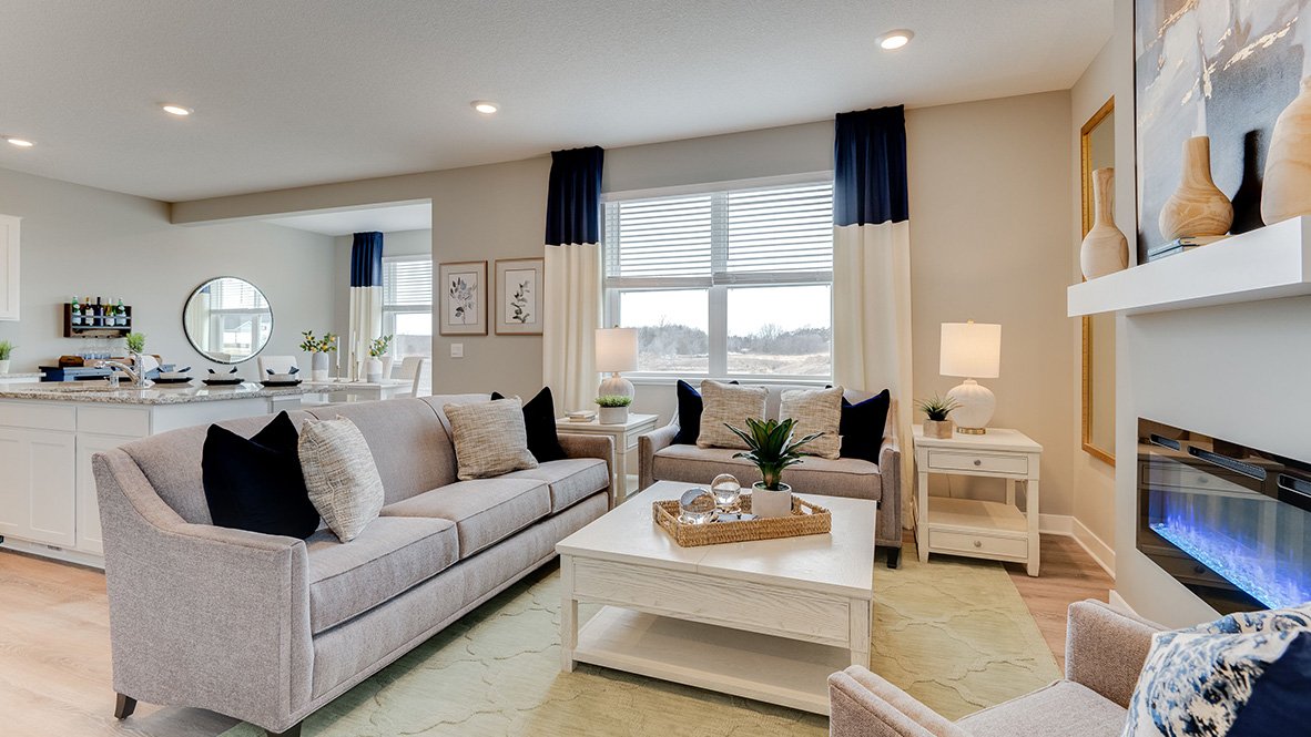 Living room area on open concept main level in new construction home.