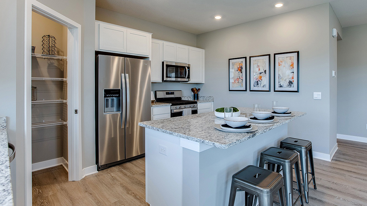 kitchen with white cabinetry, large island, and stainless steel appliances