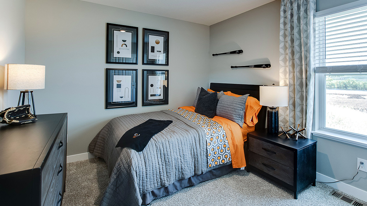 bedroom with beige carpet, grey walls and a window