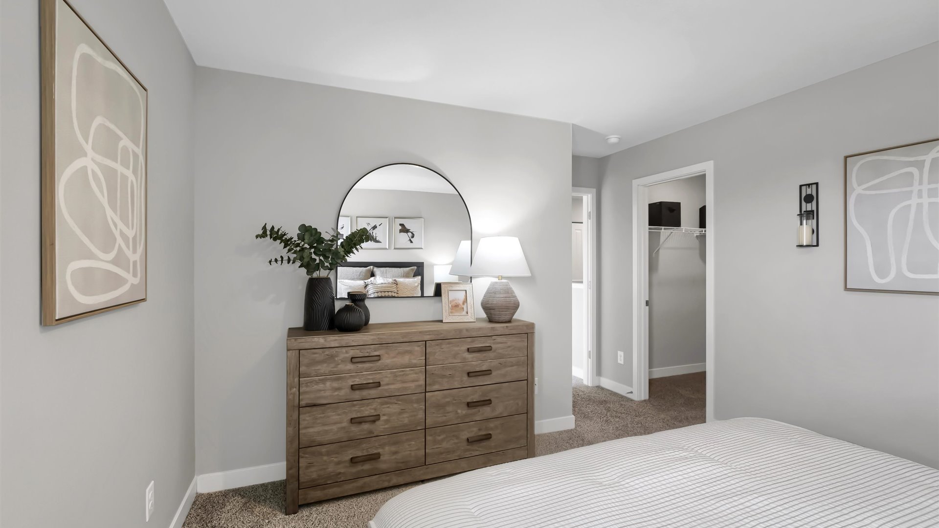 Carpeted bedroom suite with walk in closet and private bathroom.