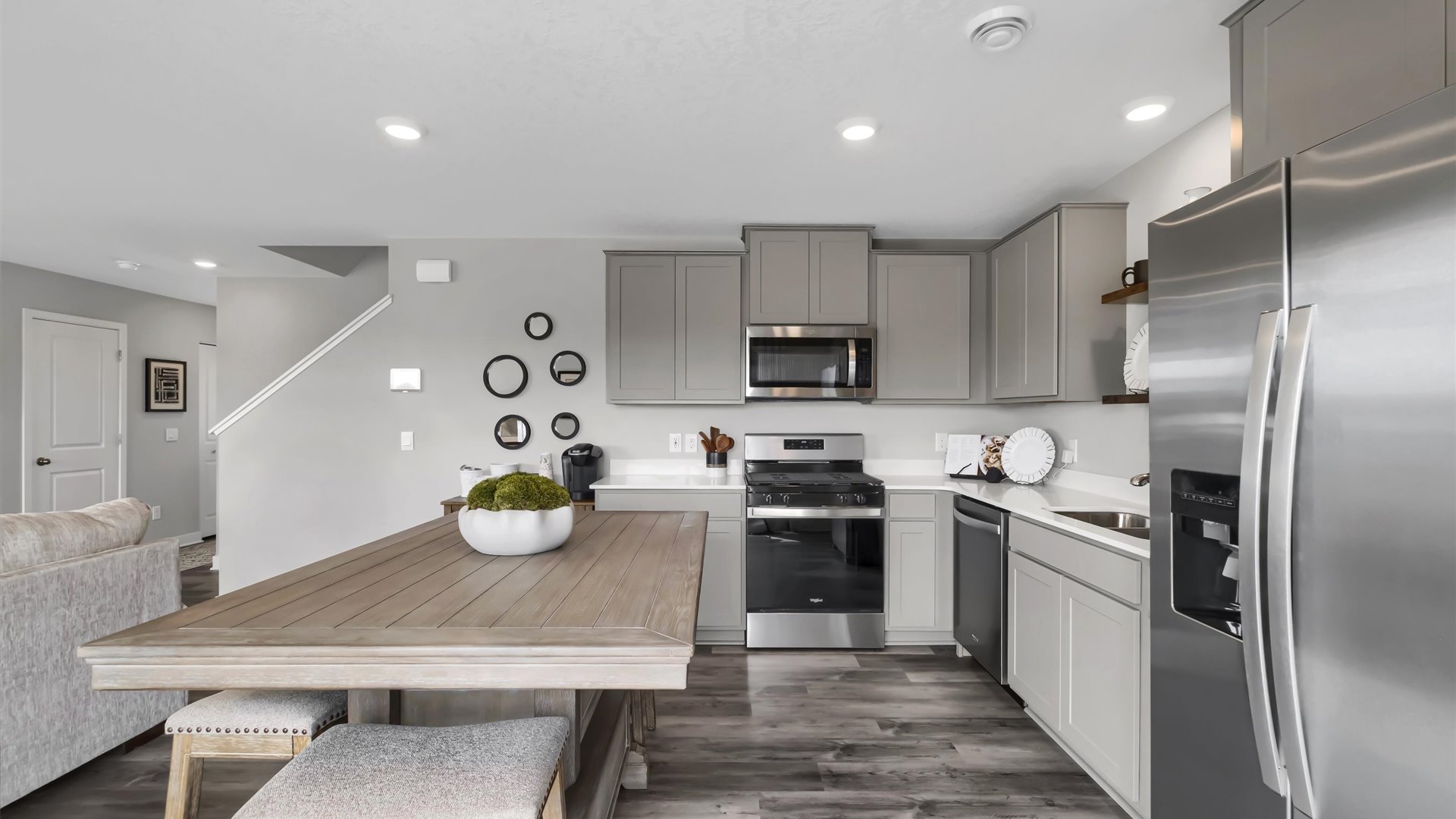kitchen with light grey cabinetry, large island and stainless steel appliances