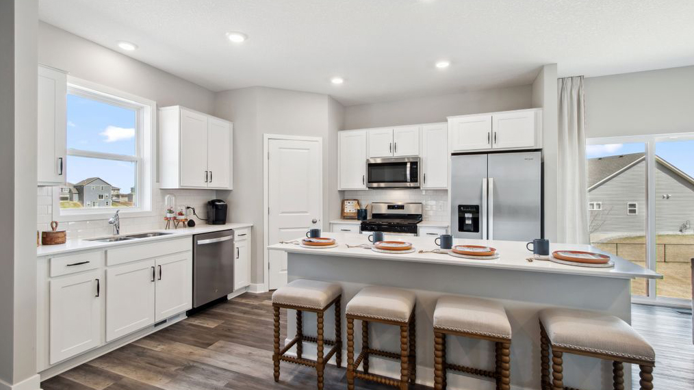 Kitchen with white cabinets and stainless steel appliances.