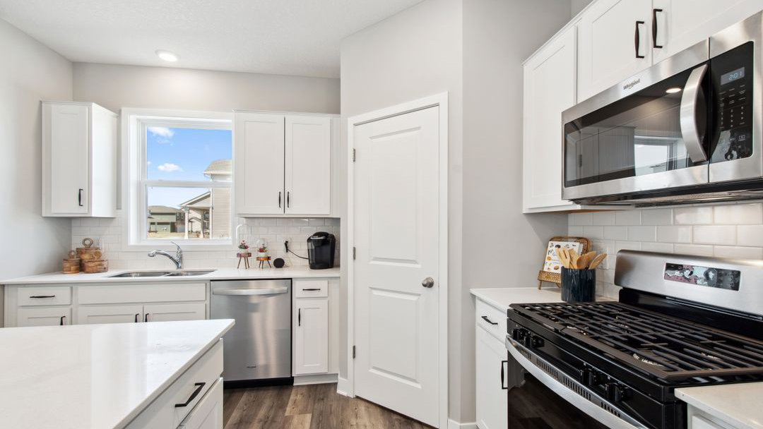 Straight on view of kitchen with four-person island.