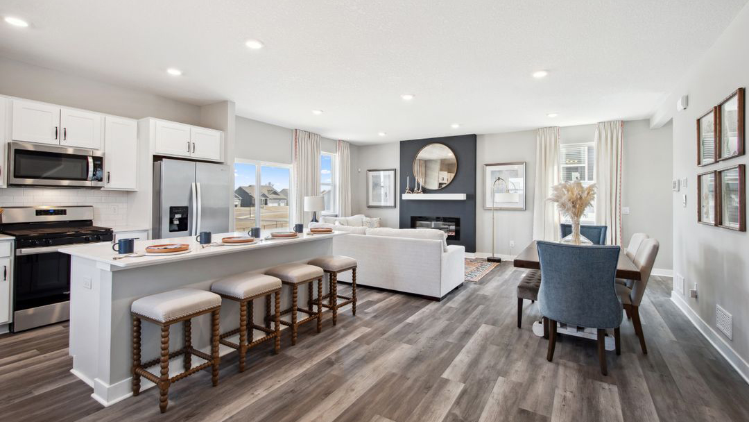 View of open concept main level with kitchen, dinette, and living room.