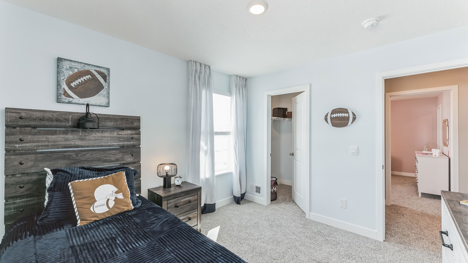 Carpeted secondary bedroom with standard closet.