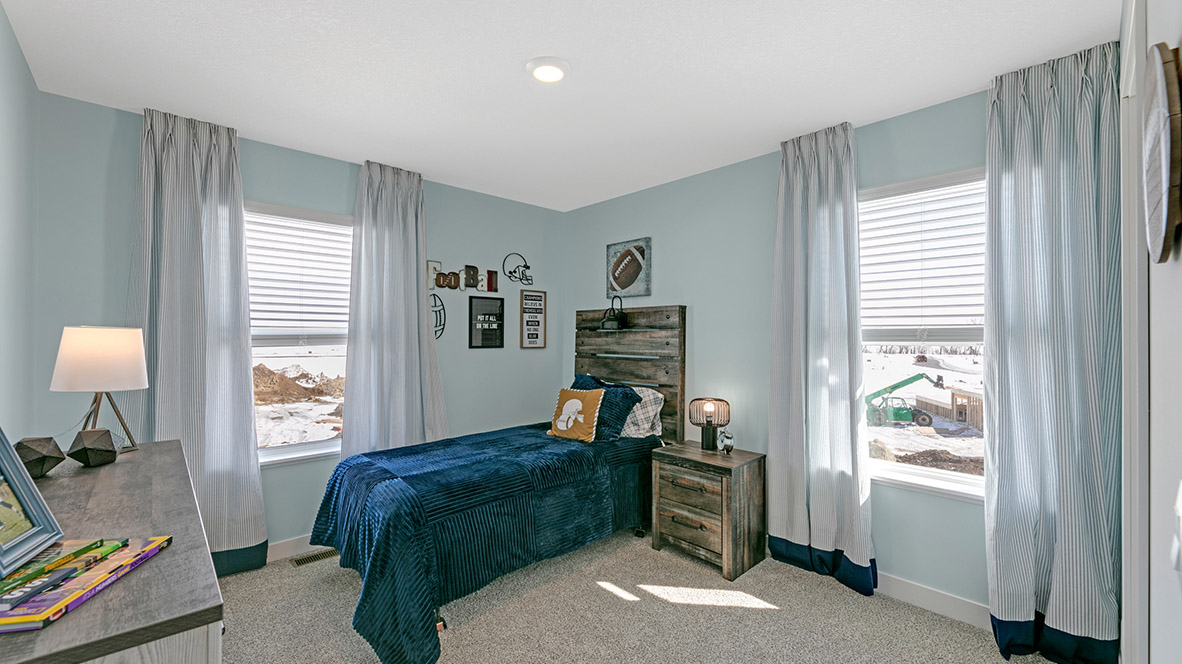 Carpeted secondary bedroom with standard closet.