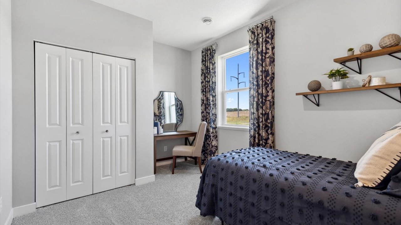 Main level bedroom with standard closet.