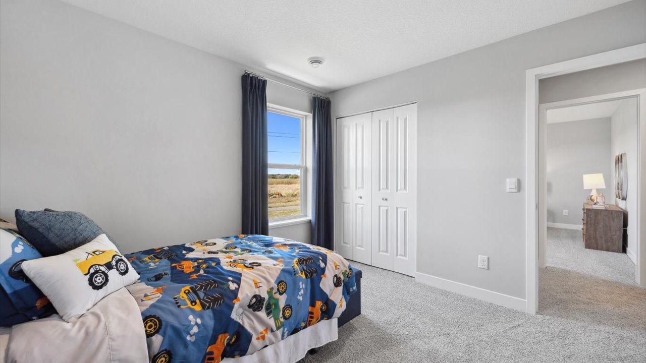 Secondary bedroom with standard closet.