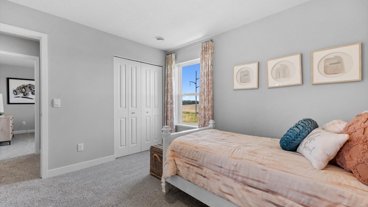 Secondary bedroom with standard closet.