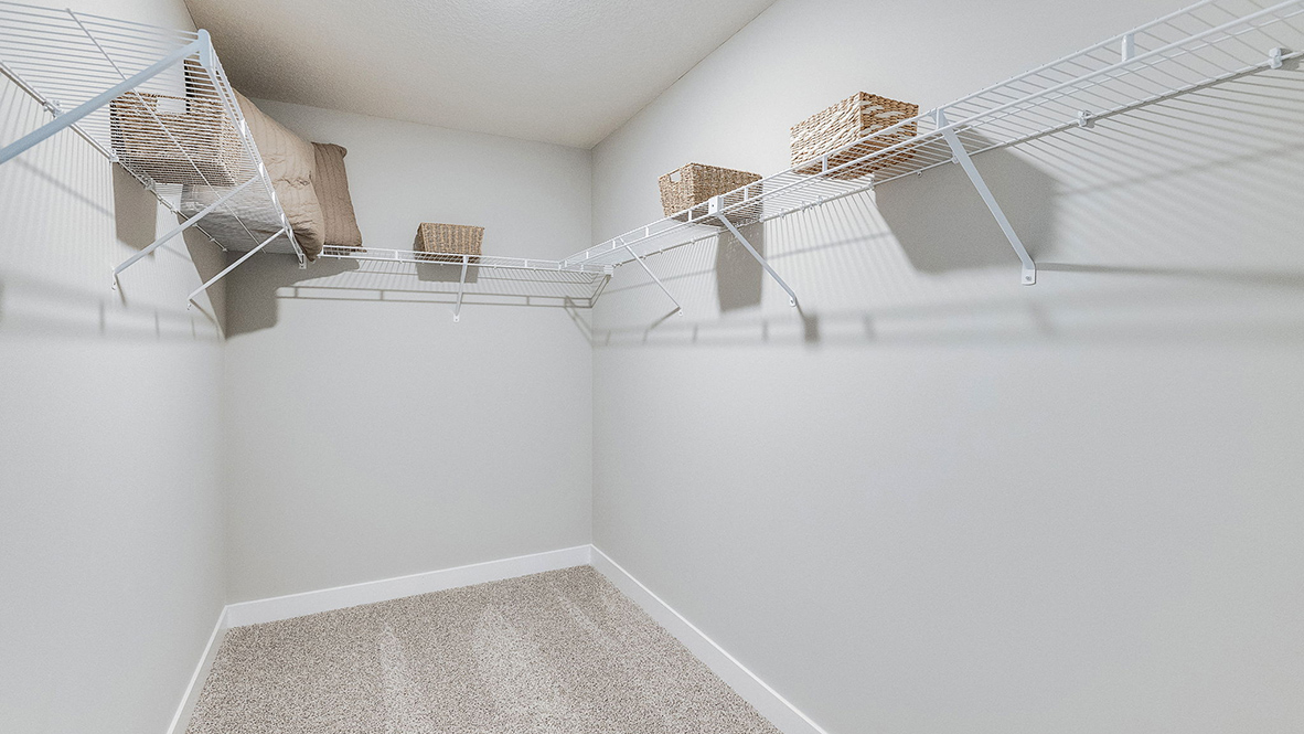 Spacious walk-in closet with wire shelving unit.Spacious walk-in closet with wire shelving unit.