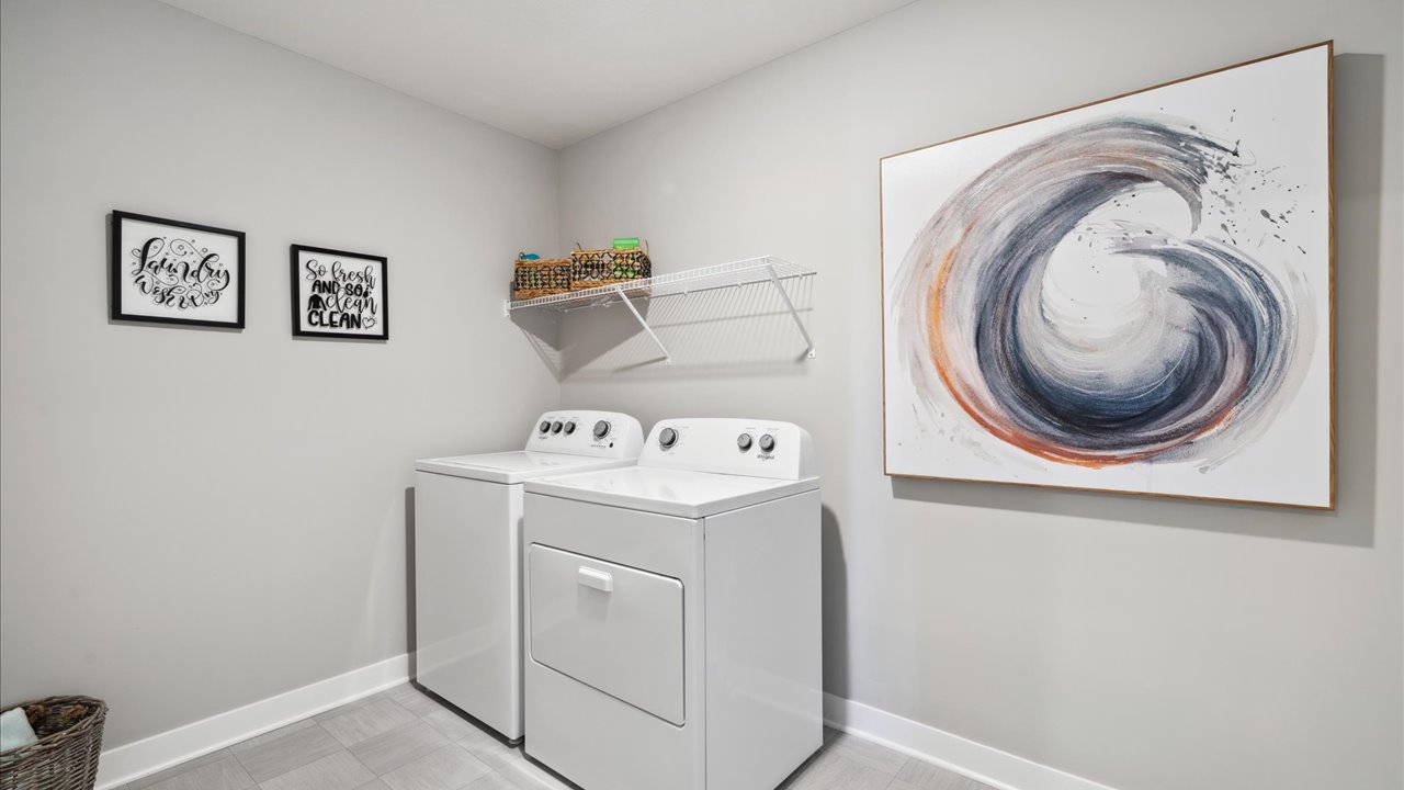 Upper level laundry room with wire shelving unit.